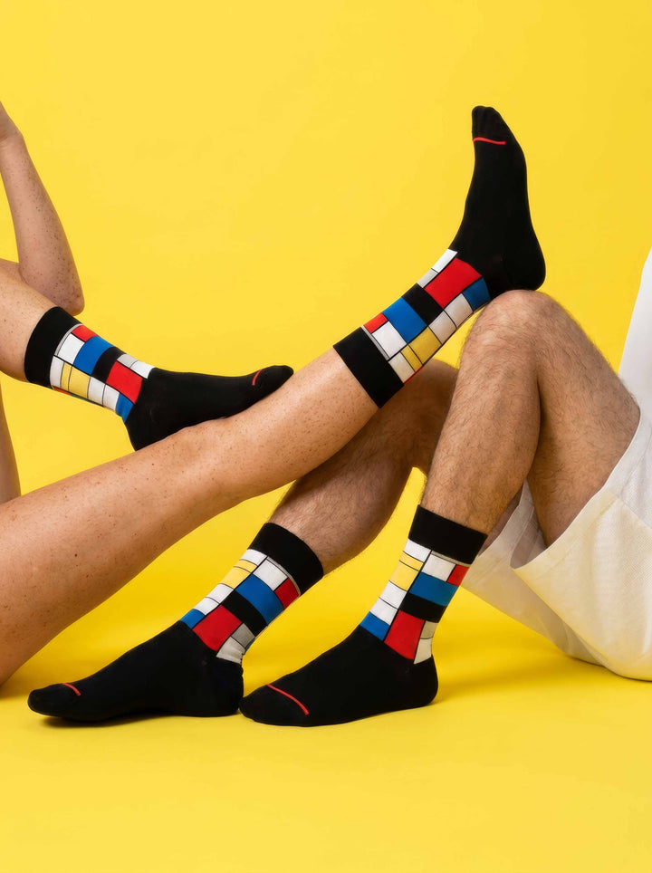 MuseARTa Mondrian art socks on yellow background — bold unisex art gift ArtyGifts
