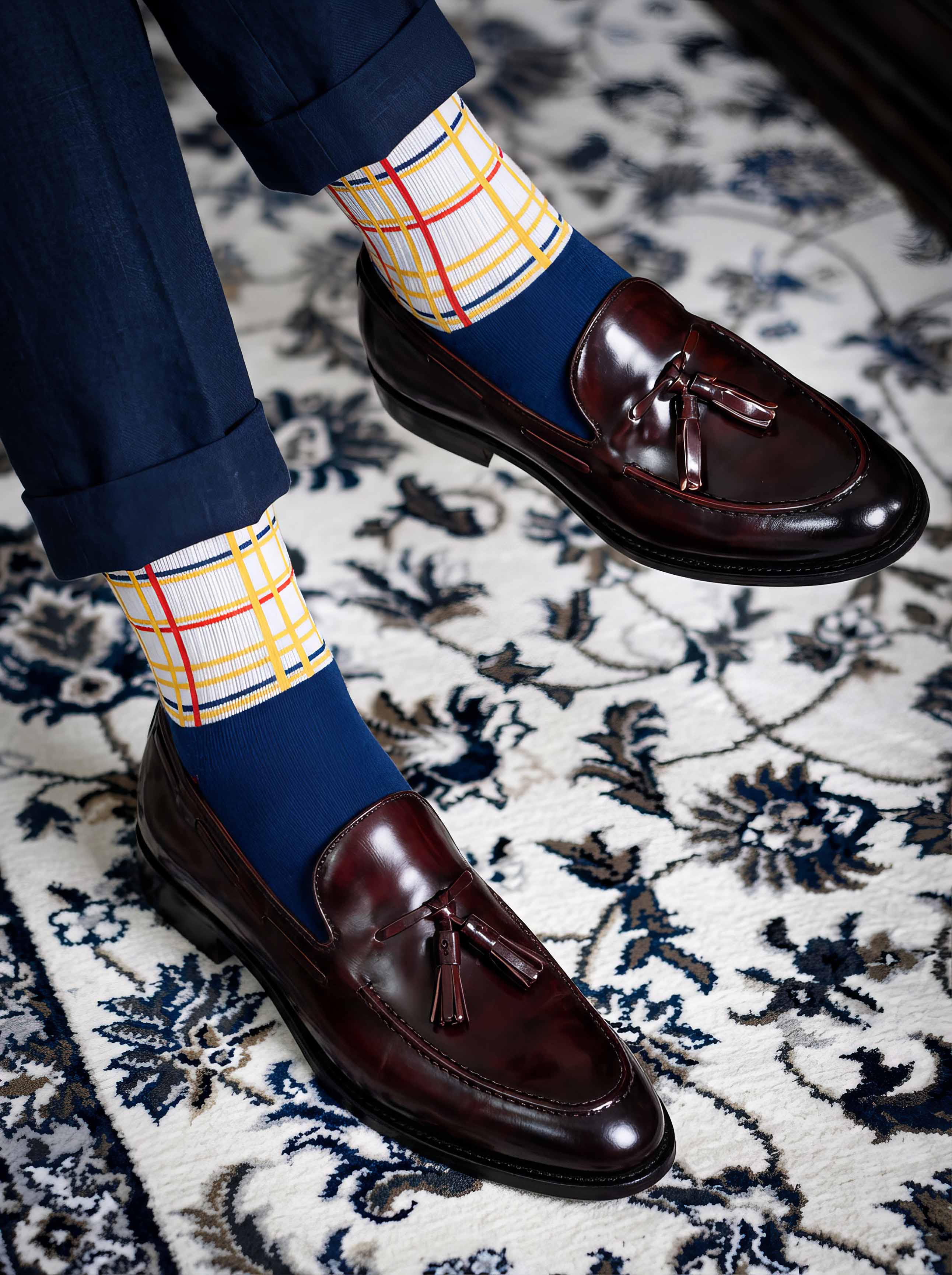 Man wearing MuseARTa Mondrian New York City art socks with brown Oxford shoes on floral background — elegant De Stijl gift ArtyGifts
