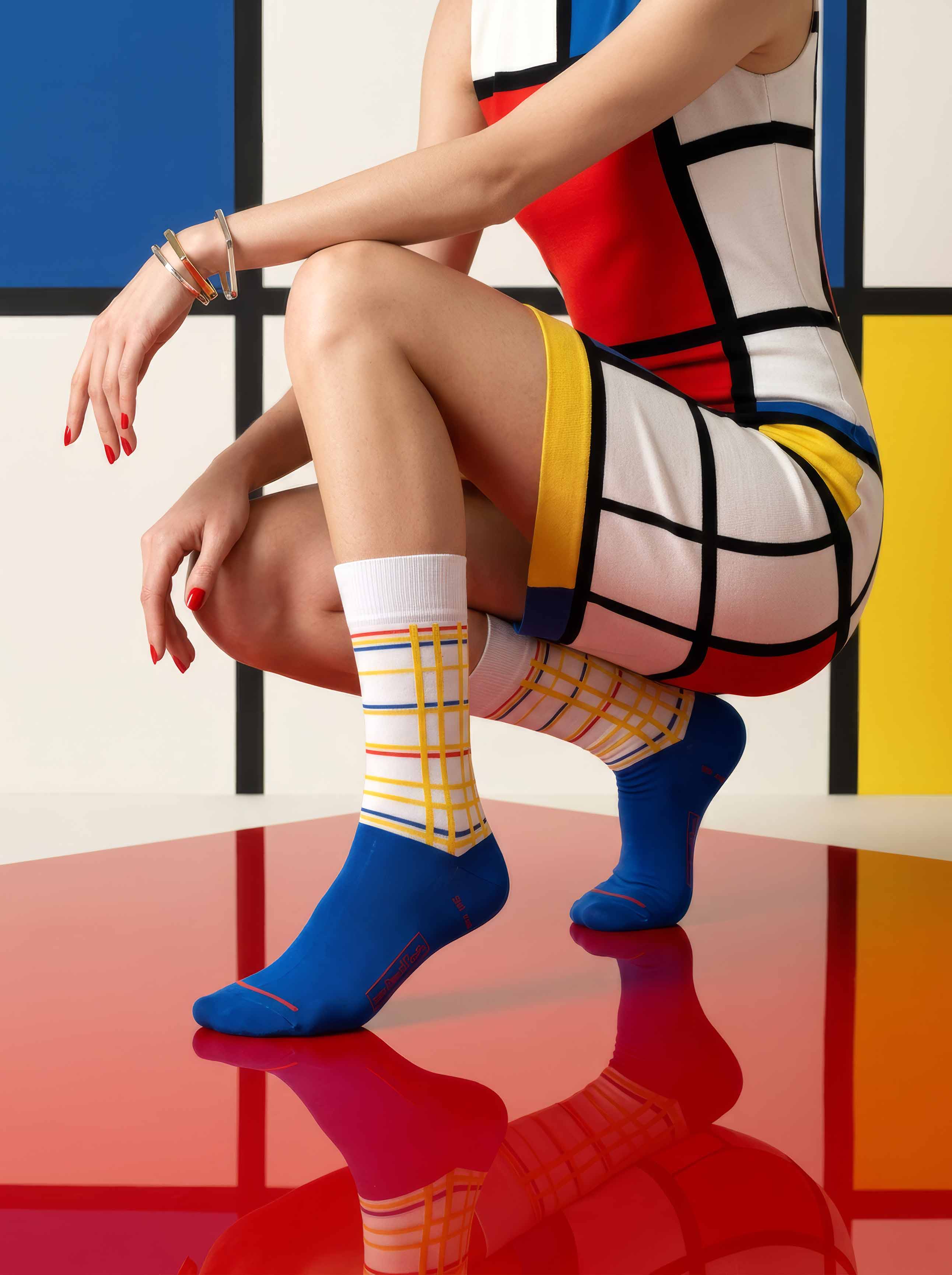 Woman in Mondrian dress wearing MuseARTa Mondrian New York City art socks — De Stijl Gemeentemuseum Den Haag fashion gift ArtyGifts
