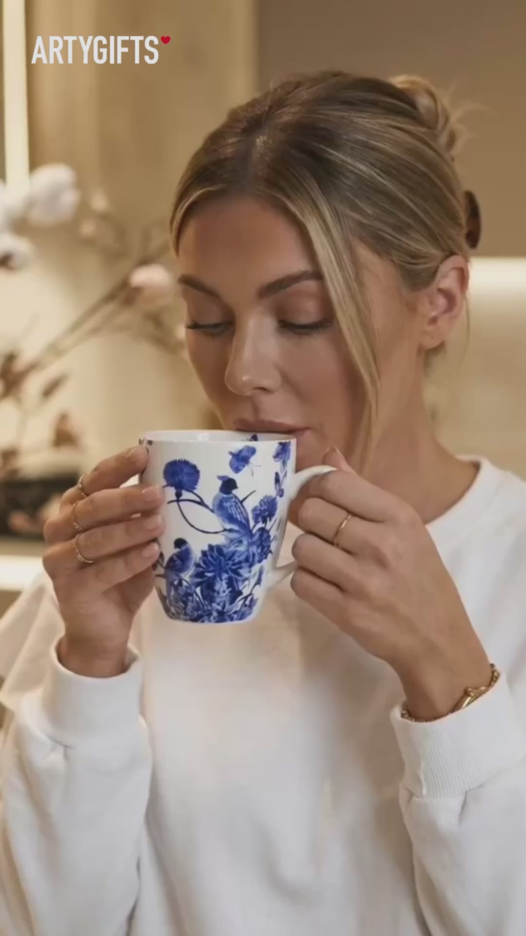 Woman enjoying coffee from an ArtyGifts Delft Blue Birds Art Mug — museum-licensed Rijksmuseum design — ArtyGifts