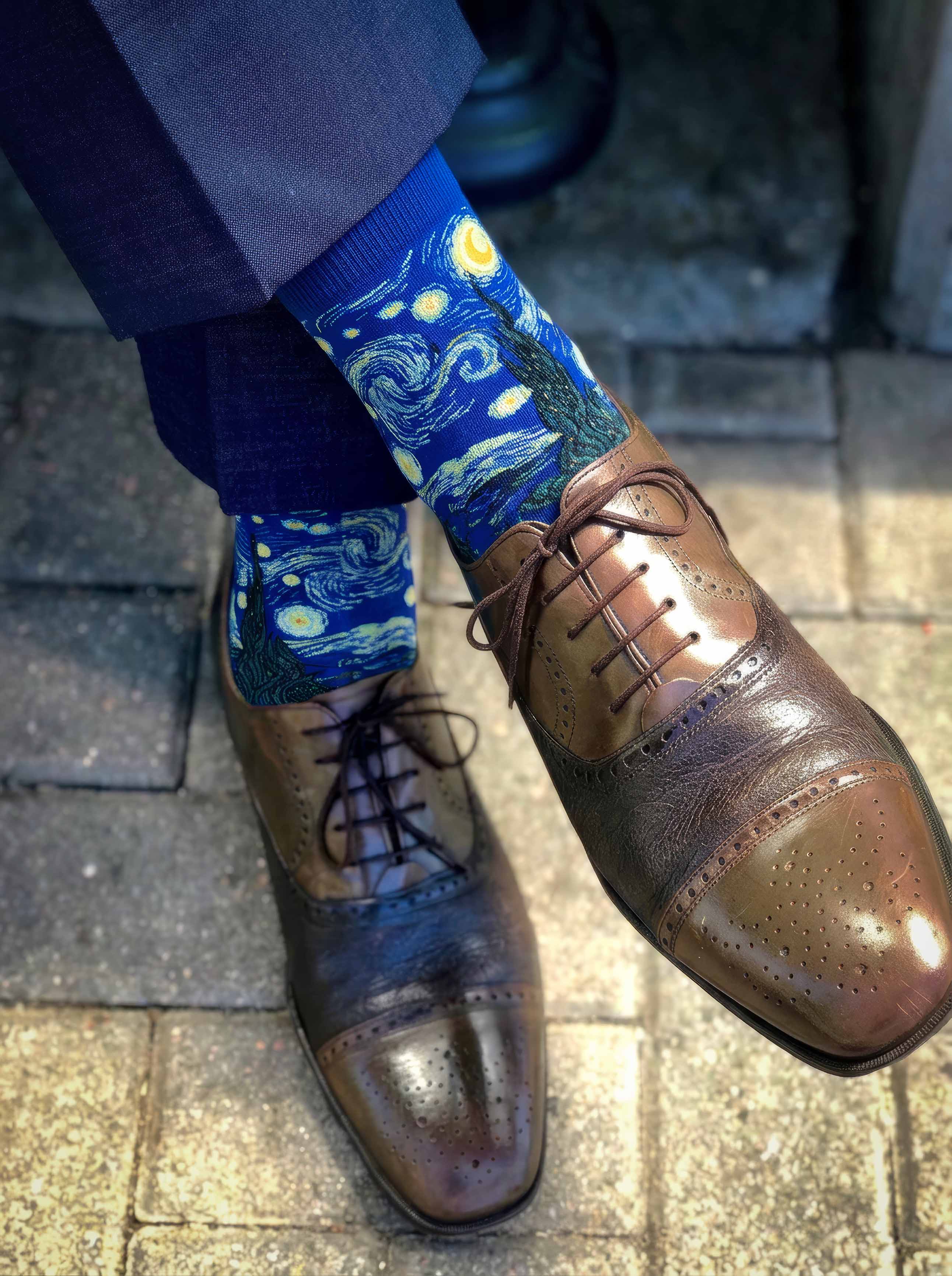 Man wearing MuseARTa Van Gogh Starry Night art socks with brown Oxford shoes on cobblestone street — elegant art gift ArtyGifts
