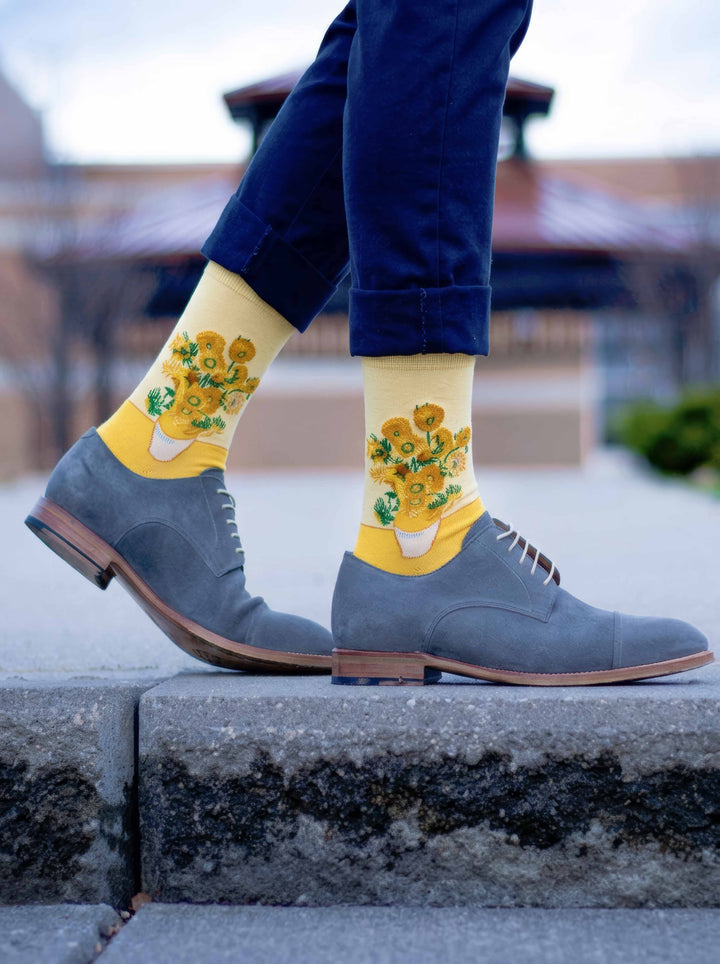 Man wearing Van Gogh Sunflowers art socks with grey Oxford shoes on steps — classic art gift ArtyGifts