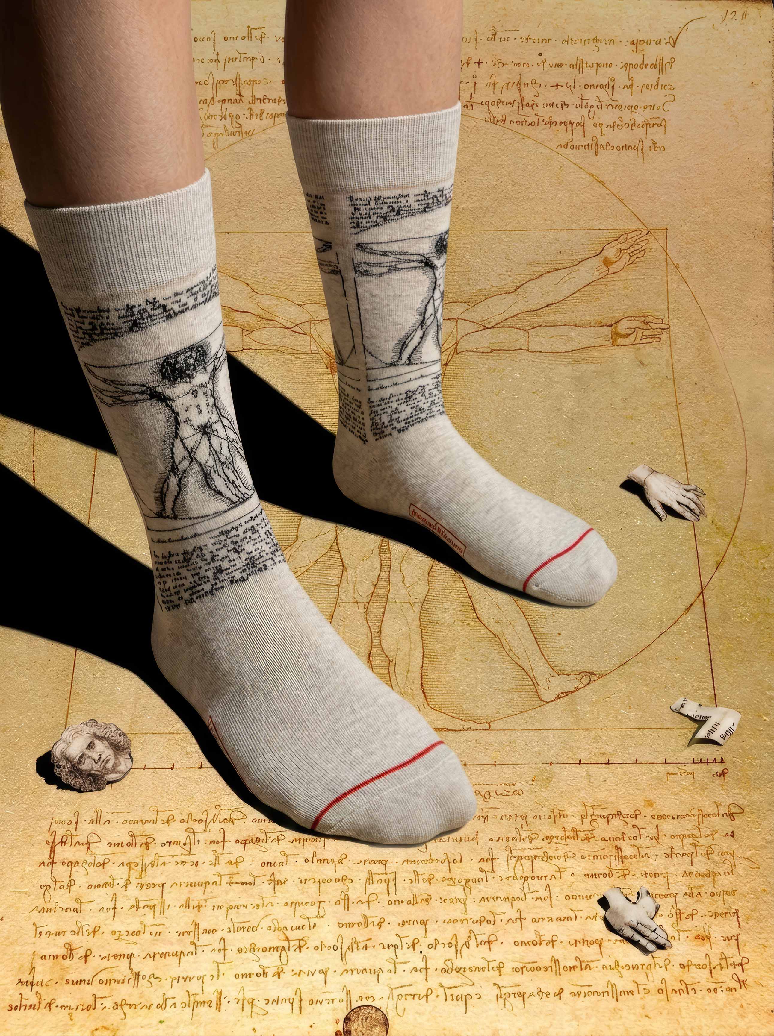 Da Vinci Vitruvian Man art socks on Da Vinci anatomical sketch background — museum art gift ArtyGifts